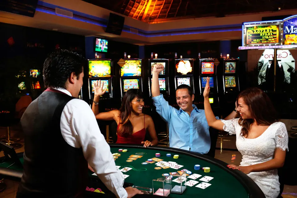 People celebrating at a casino table inside the resort at Bahia Principe Luxury Sian Ka'an