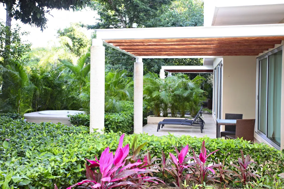 Private terrace with pergola, lounge chairs and tub at Bahia Principe Luxury Sian Ka'an