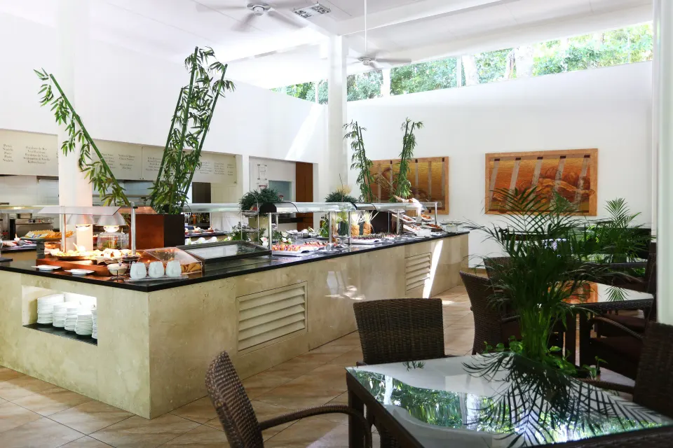 Buffet island with food stations and wicker seating at Bahia Principe Luxury Sian Ka'an
