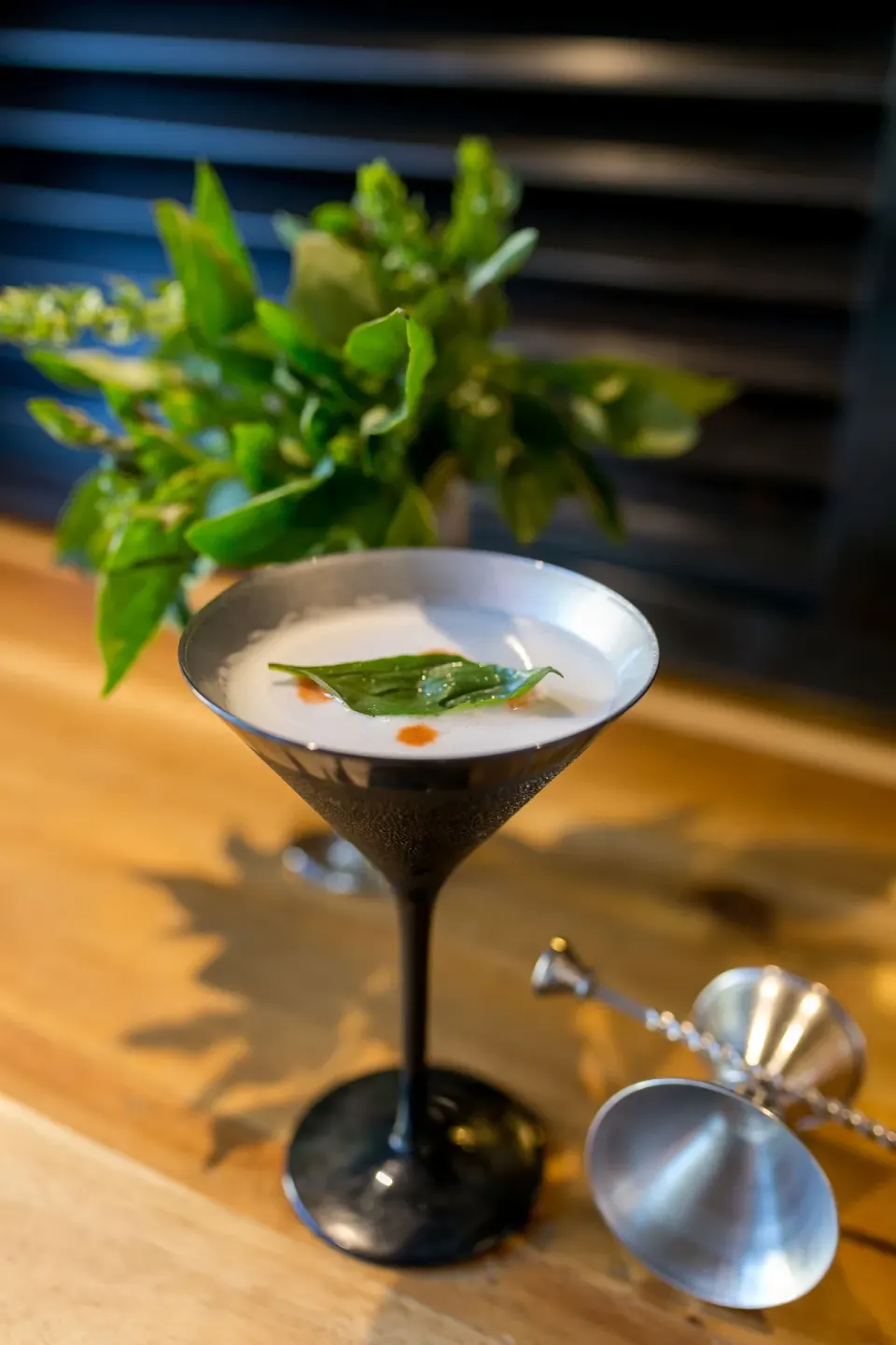 Cocktail in a black-stem martini glass on a bar at Bahia Principe Luxury Sian Ka'an