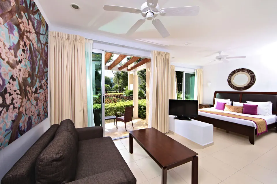 Junior Room (Superior) king bed and patio with garden view at Bahia Principe Luxury Sian Ka'an