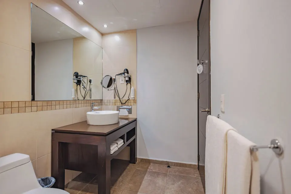 Junior Suite bathroom vanity and mirror at Bahia Principe Luxury Sian Ka'an