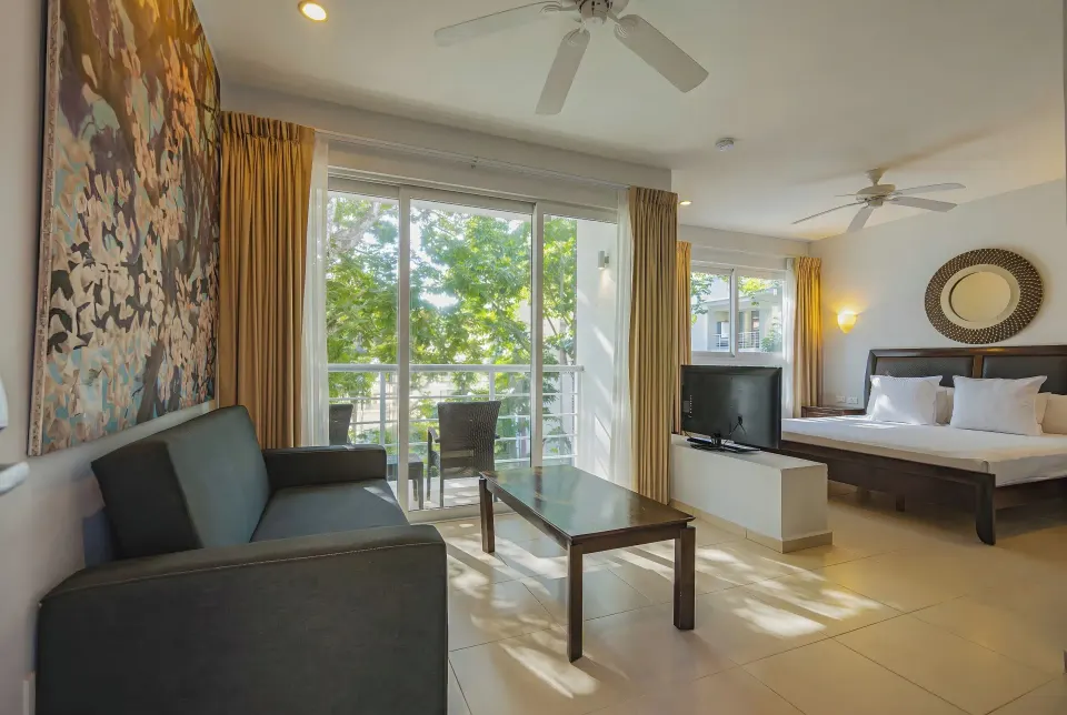 Junior Suite with king bed, sofa and balcony at Bahia Principe Luxury Sian Ka'an
