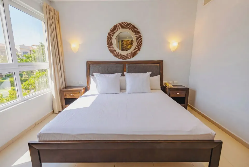 King bed in junior suite with window light at Bahia Principe Luxury Sian Ka'an