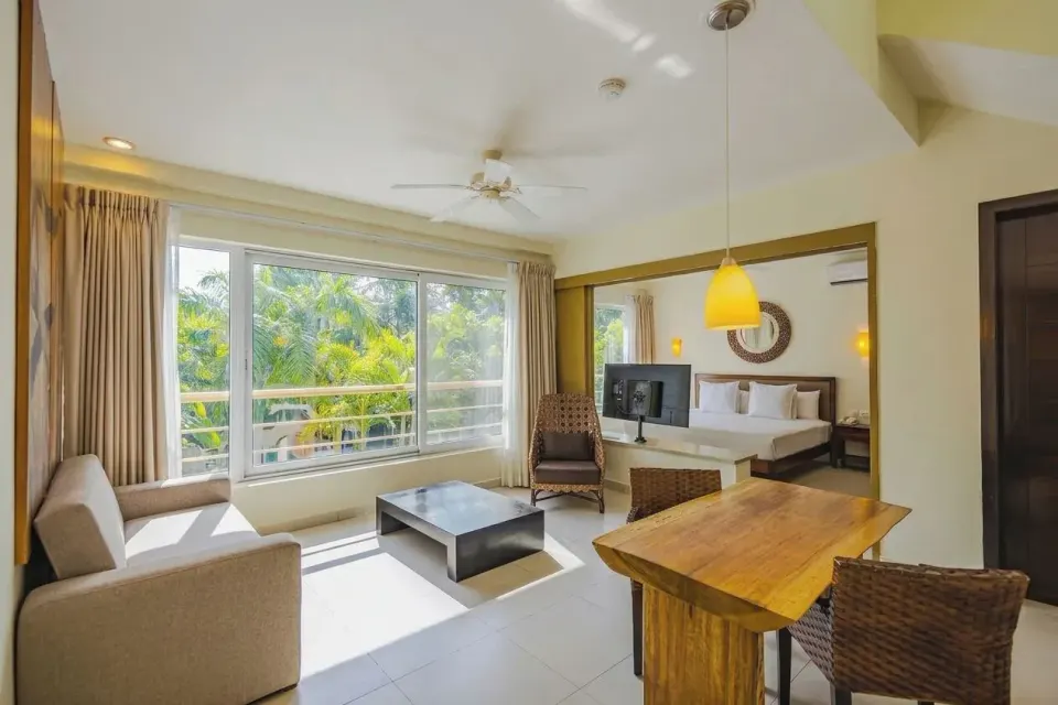 Junior Suite living area with sofa, table and view at Bahia Principe Luxury Sian Ka'an
