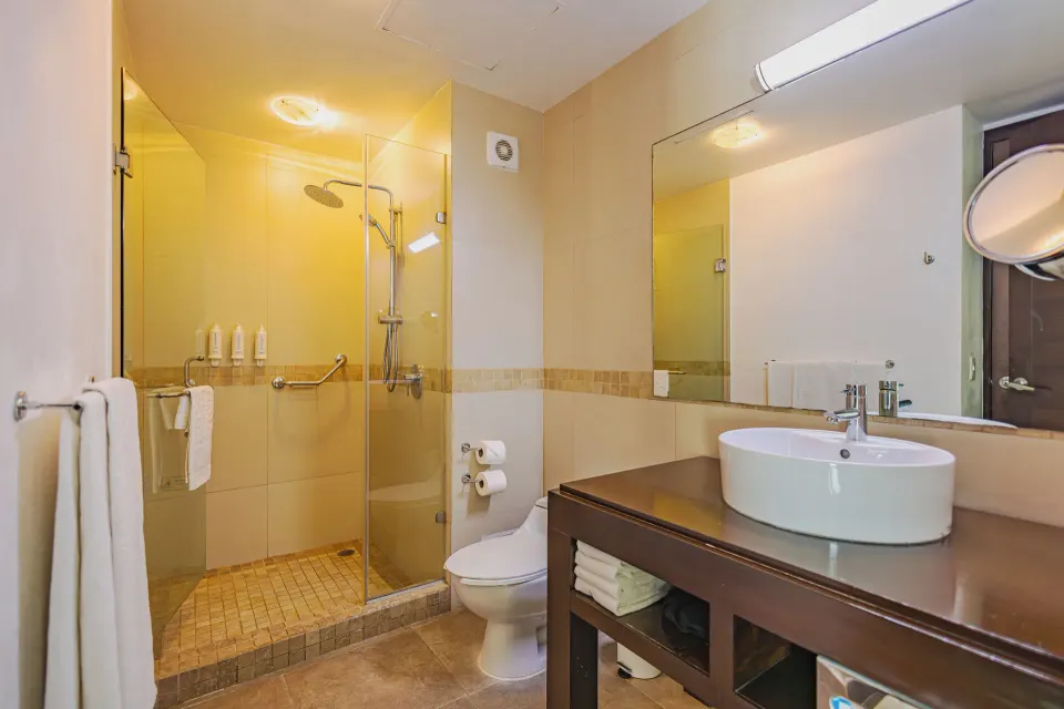 Bathroom with glass-enclosed shower and circular sink in a Junior Suite at Bahia Principe Luxury Sian Ka'an