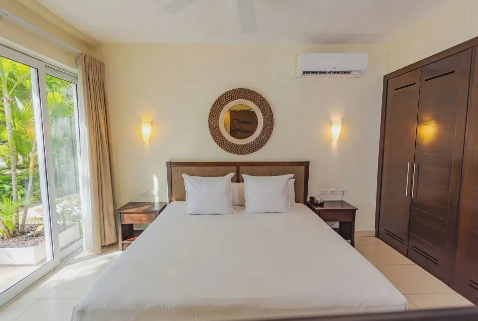 King bed headboard and wardrobe in a Junior Suite Garden View at Bahia Principe Luxury Sian Ka'an