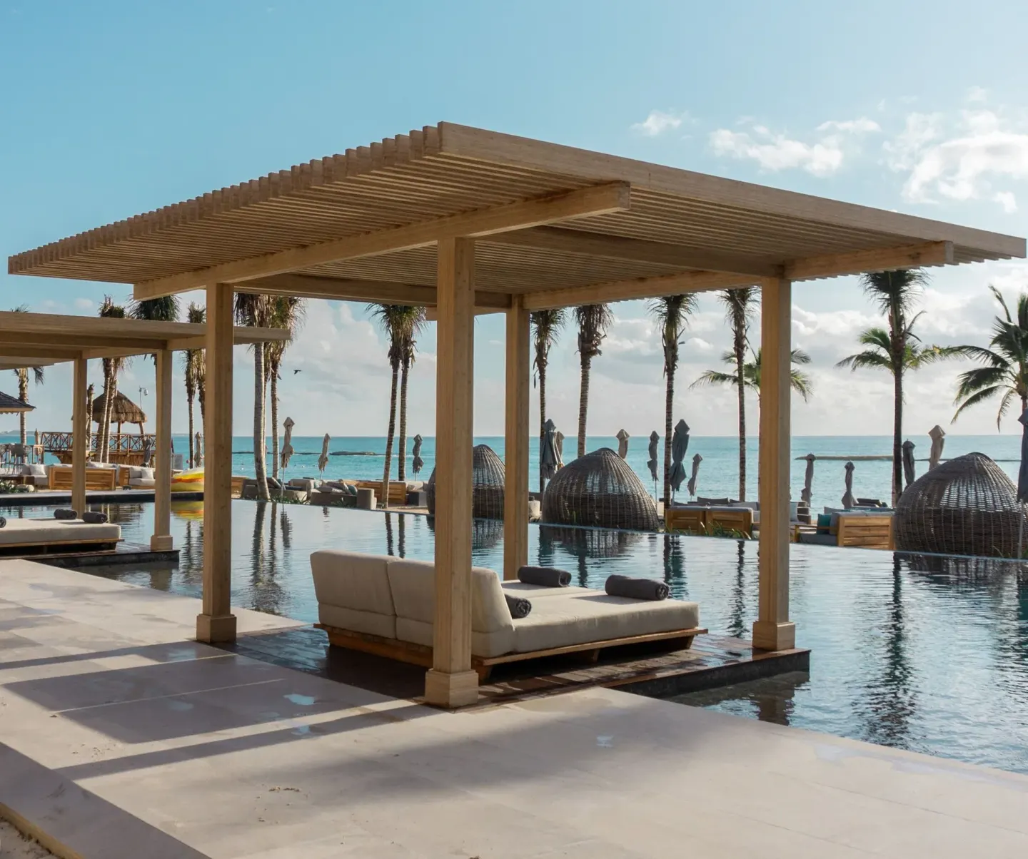 Beachfront pool cabana with daybed and ocean view at Banyan Tree Mayakoba.