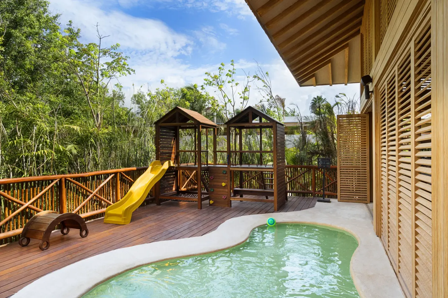 A children’s pool and play structure sit on a wooden deck at Banyan Tree Mayakoba.