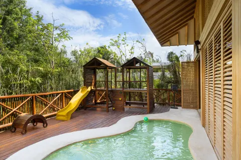 A children’s pool and play structure sit on a wooden deck at Banyan Tree Mayakoba.