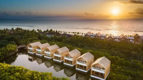 Aerial sunset view of lagoon villas and the coast at Banyan Tree Mayakoba.