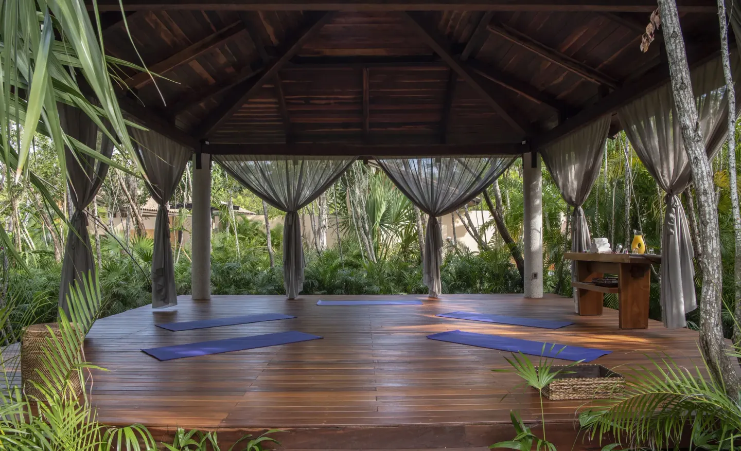 Open-air yoga pavilion with mats in the jungle at Banyan Tree Mayakoba.