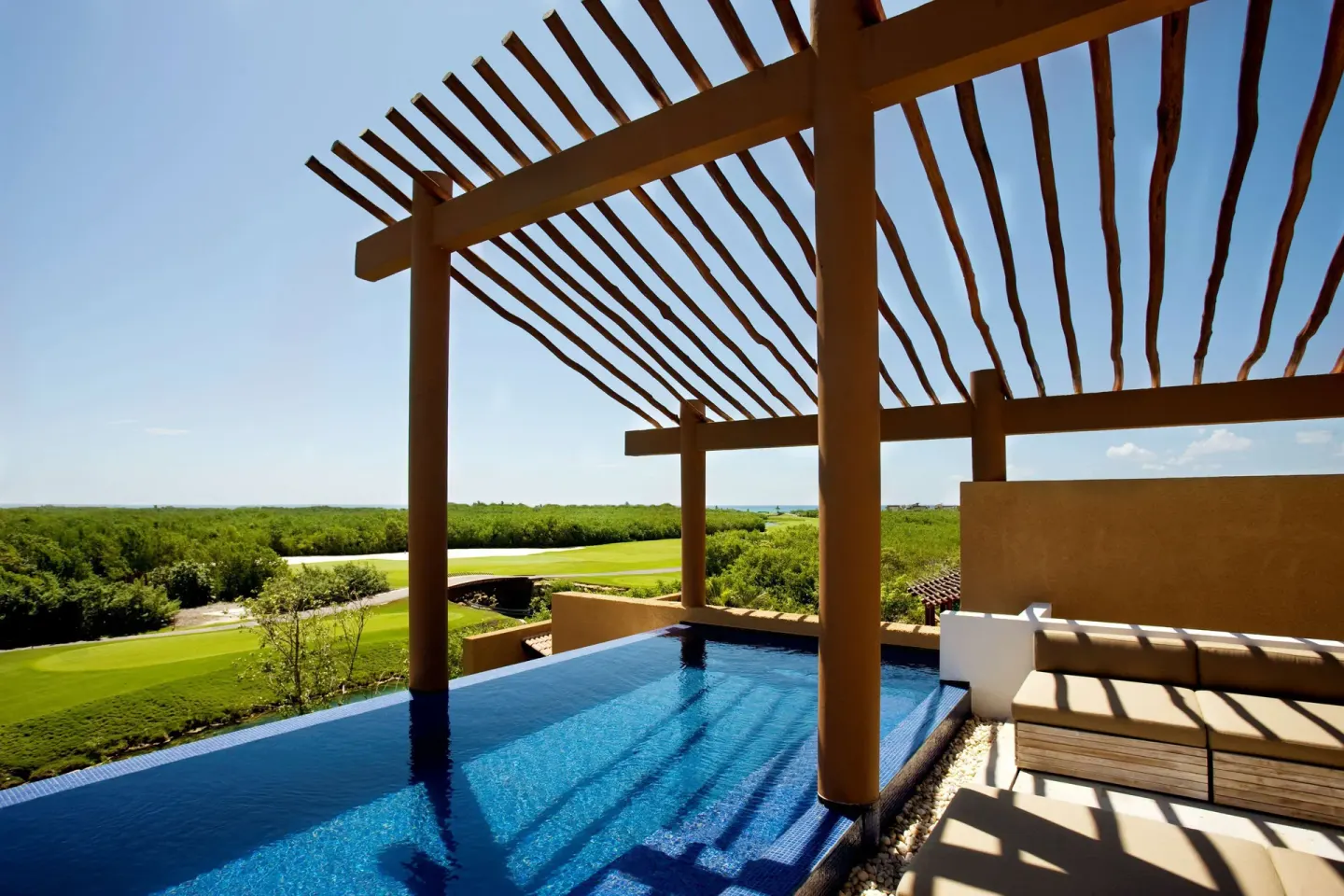 Private plunge pool and shaded terrace with treetop views at Banyan Tree Mayakoba.