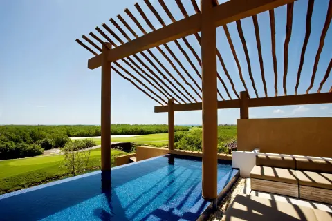 Private plunge pool and shaded terrace with treetop views at Banyan Tree Mayakoba.