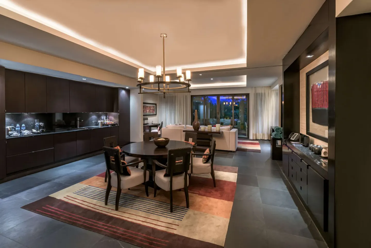 Suite dining area and lounge with kitchenette at Banyan Tree Mayakoba.