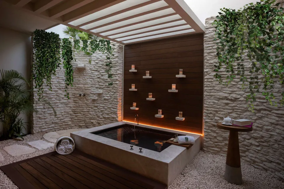 Beachfront Lanai Pool Suite bathing area at Banyan Tree Mayakoba with soaking tub and candle shelves.