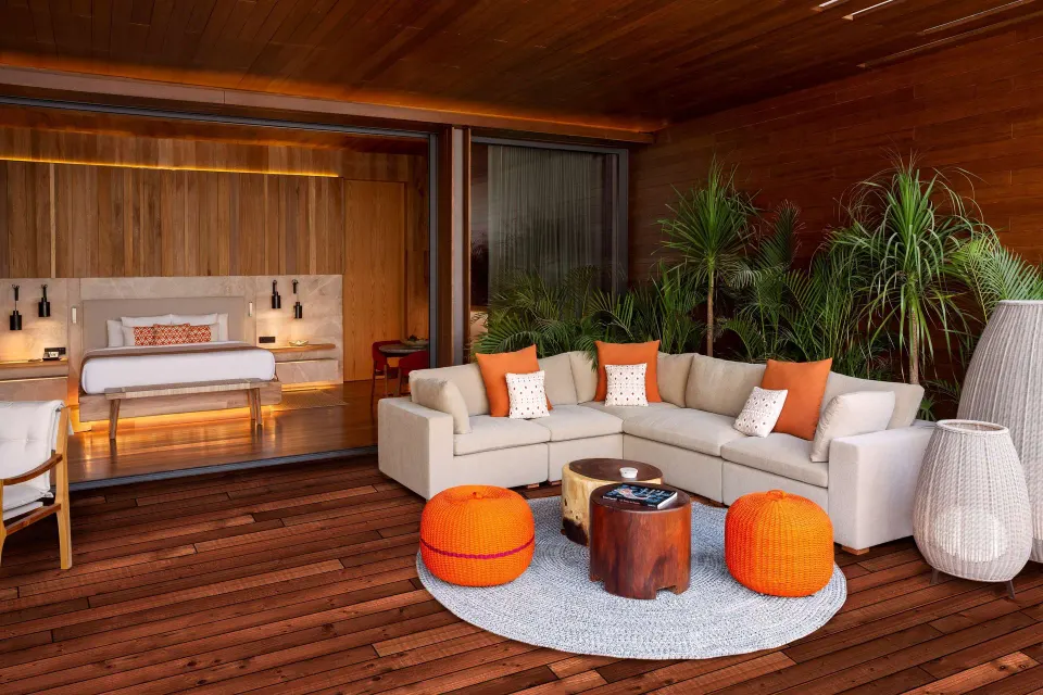 Beachfront Lanai Pool Suite terrace at Banyan Tree Mayakoba with sofa seating outside the bedroom.
