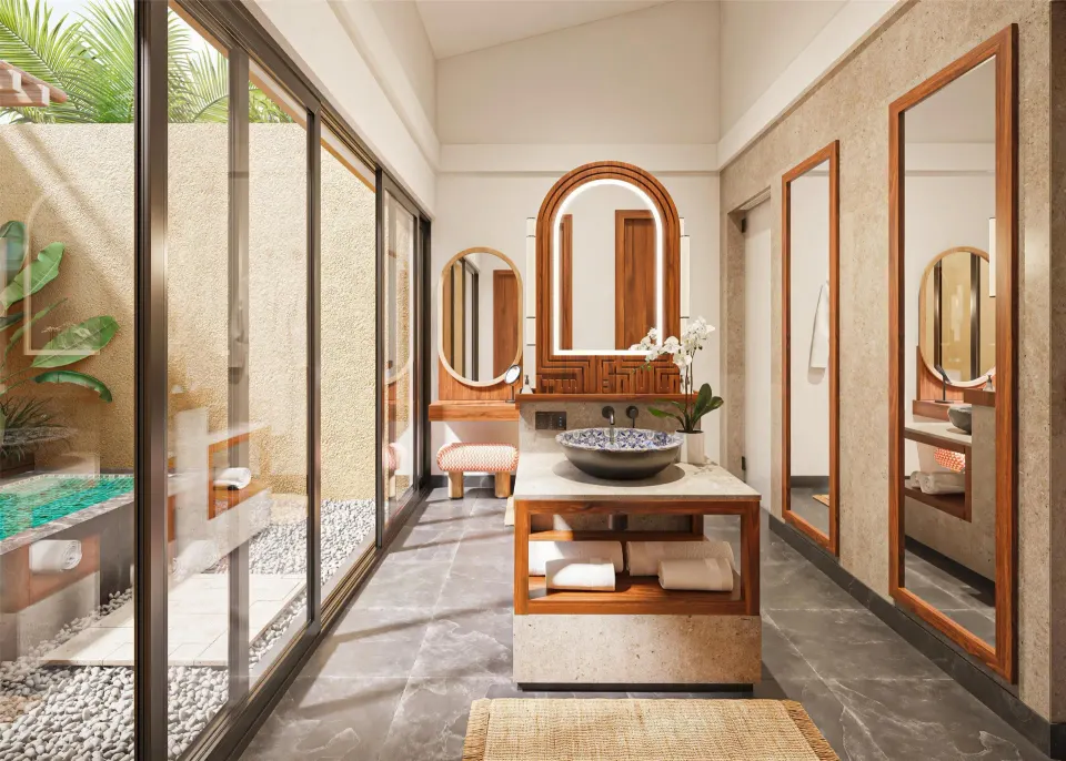 Bliss Pool Villa bathroom vanity with mirrors and poolside glass doors at Banyan Tree Mayakoba.