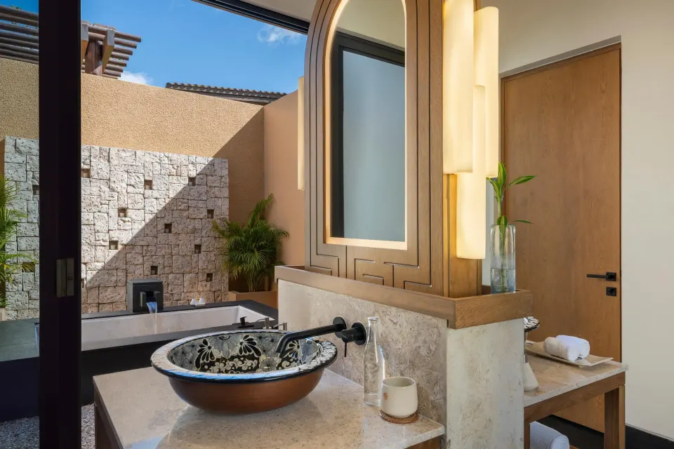 Bliss Pool Villa bathroom vanity and outdoor tub area at Banyan Tree Mayakoba.