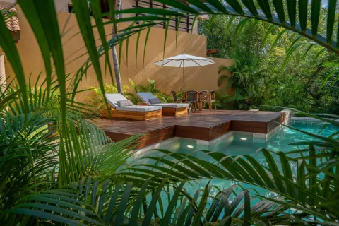 Bliss Pool Villa private pool and deck framed by palms at Banyan Tree Mayakoba.