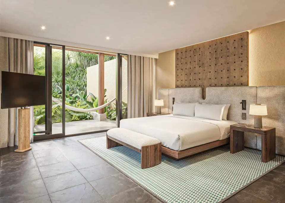 King bedroom with patio hammock in the Harmony Three-Bedroom Beachfront Pool villa at Banyan Tree Mayakoba.
