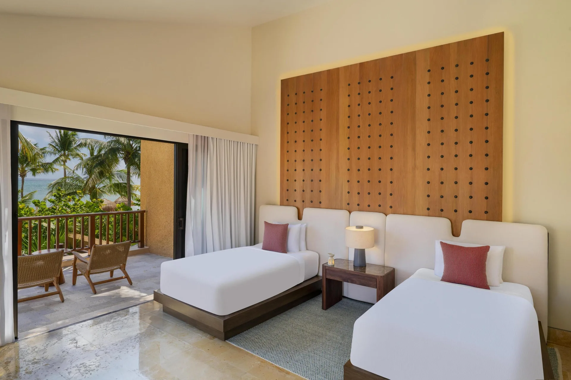 Twin bedroom with balcony and ocean glimpses at Banyan Tree Mayakoba.