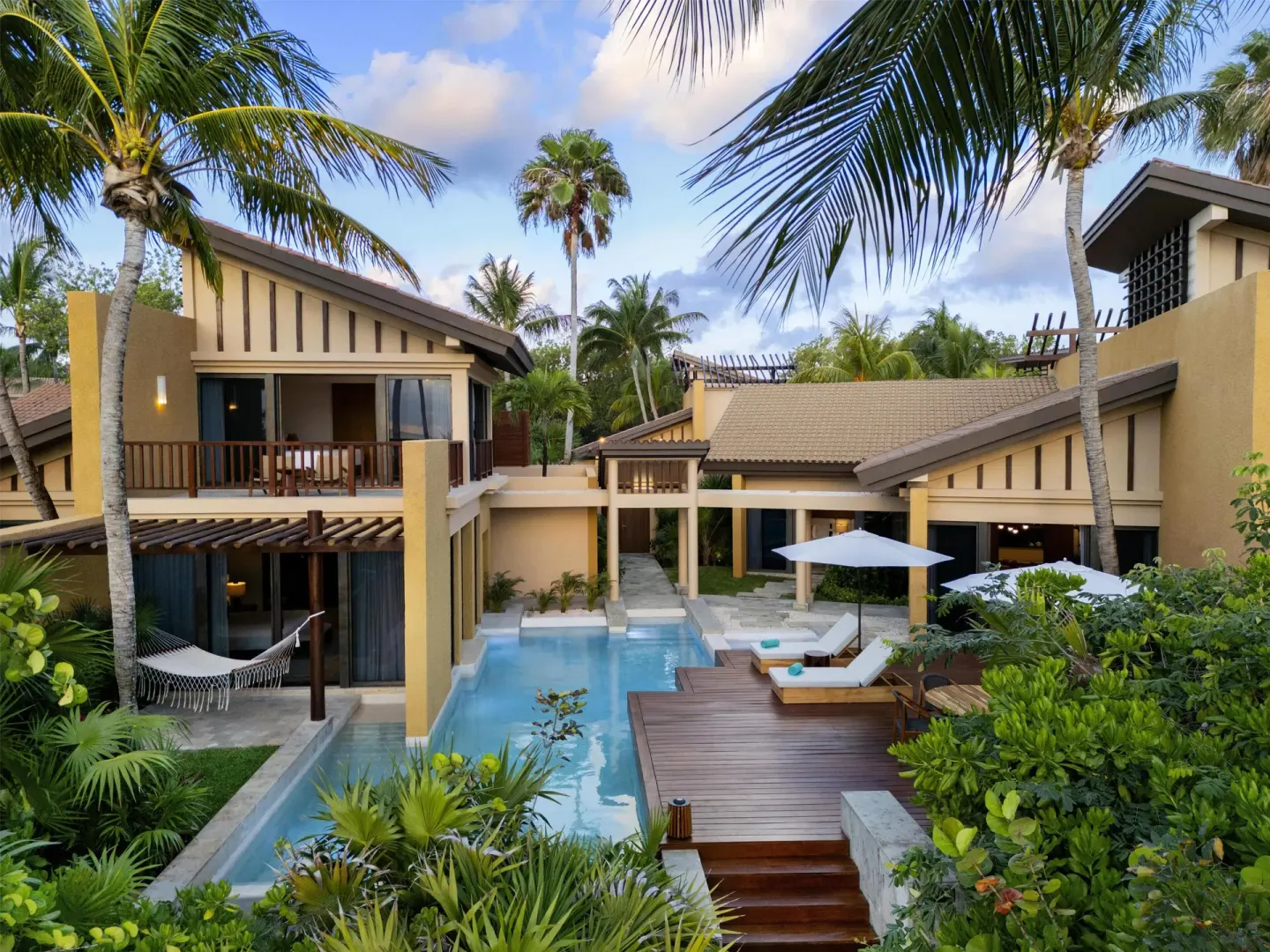 Beachfront pool villa exterior with palms and deck at Banyan Tree Mayakoba.