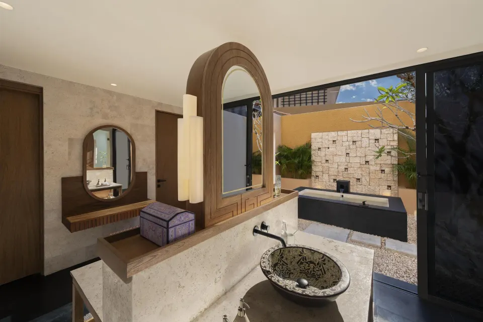 Bathroom vanity and outdoor tub at the Harmony Two-Bedroom Lagoon Pool Villa at Banyan Tree Mayakoba.