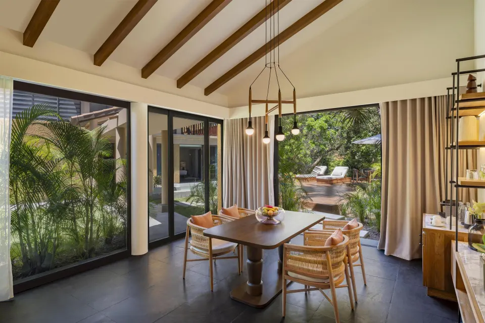 Dining area facing the deck in the Harmony Two-Bedroom Lagoon Pool Villa at Banyan Tree Mayakoba.