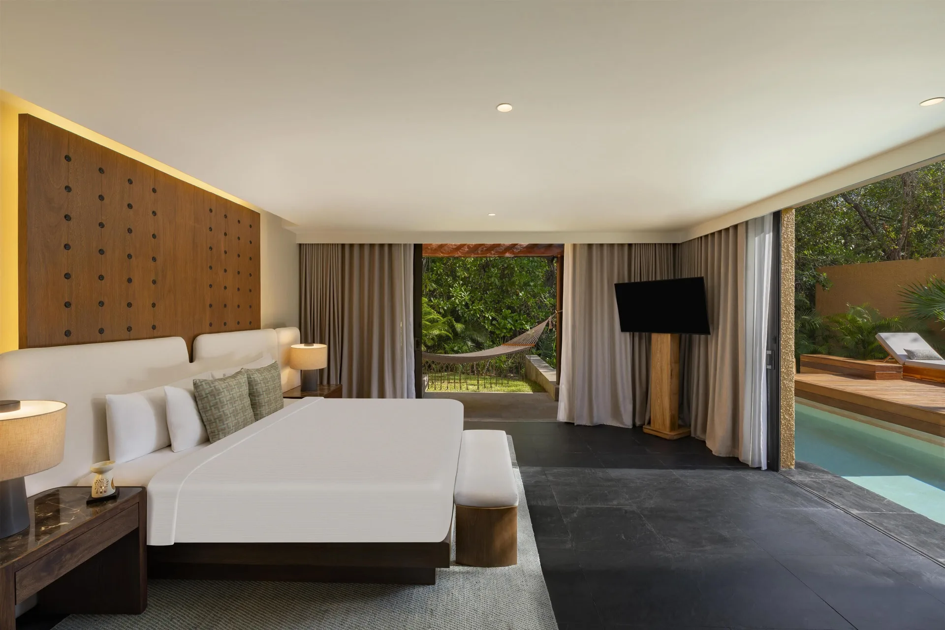 King bedroom opening to the pool at the Harmony Two-Bedroom Lagoon Pool Villa at Banyan Tree Mayakoba.