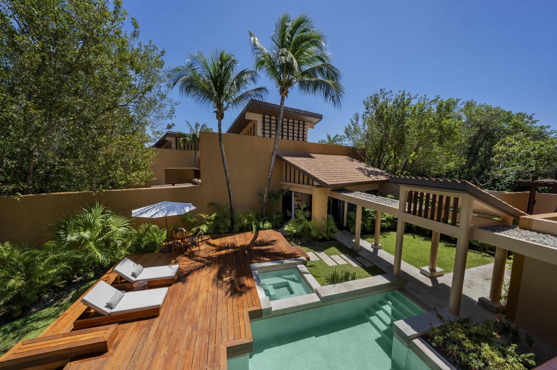 Private pool deck of the Harmony Two-Bedroom Lagoon Pool Villa at Banyan Tree Mayakoba.