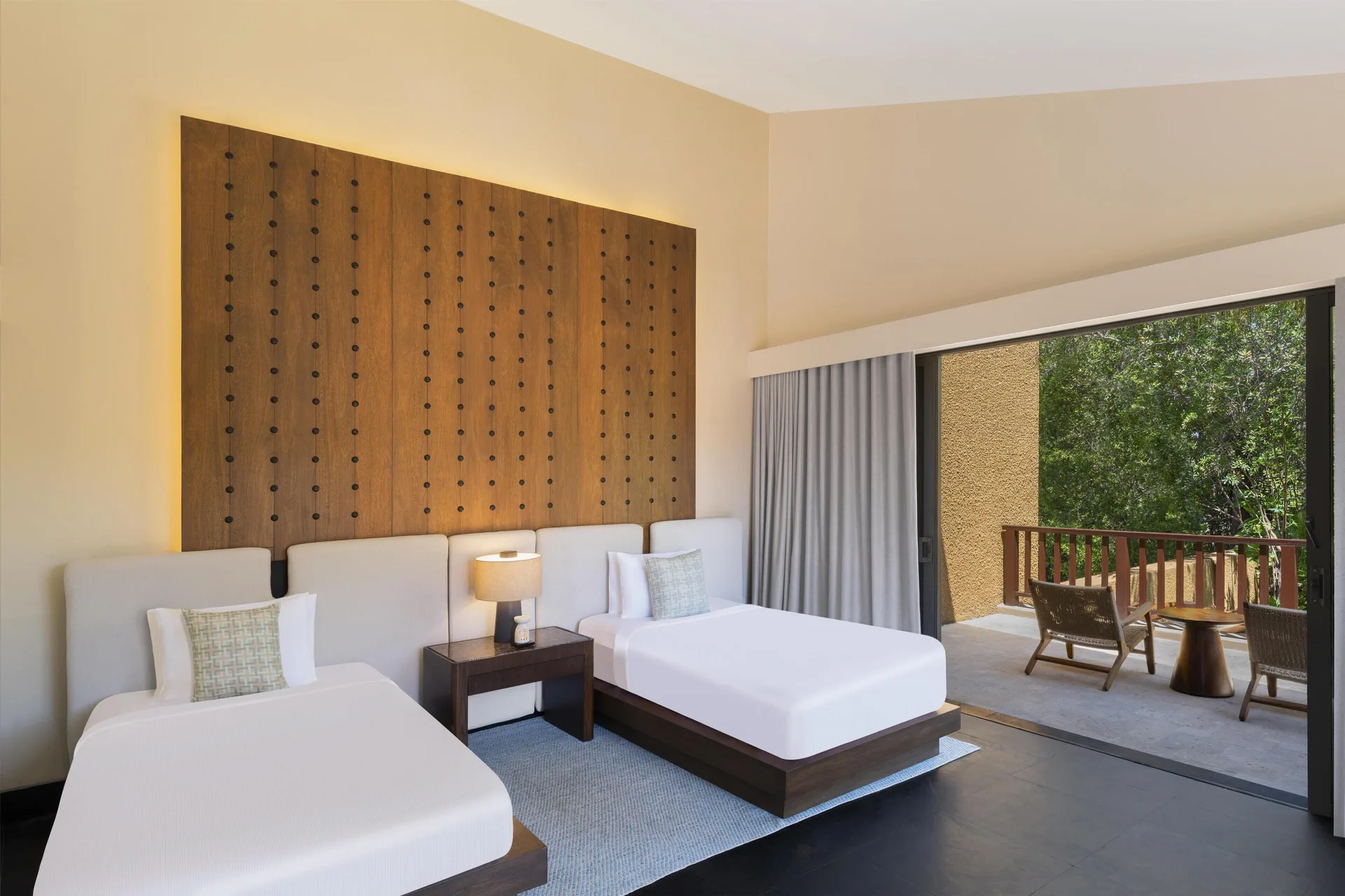 Twin bedroom with balcony in the Harmony Two-Bedroom Lagoon Pool Villa at Banyan Tree Mayakoba.