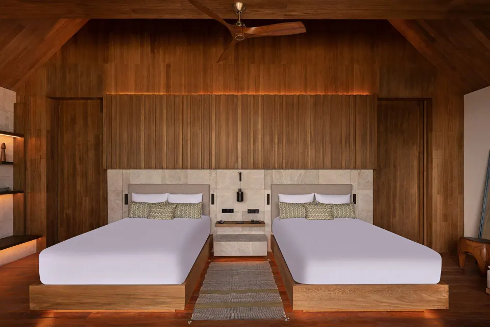 Oceanfront Veranda Pool Suite two-bed room with vaulted wood ceiling at Banyan Tree Mayakoba.