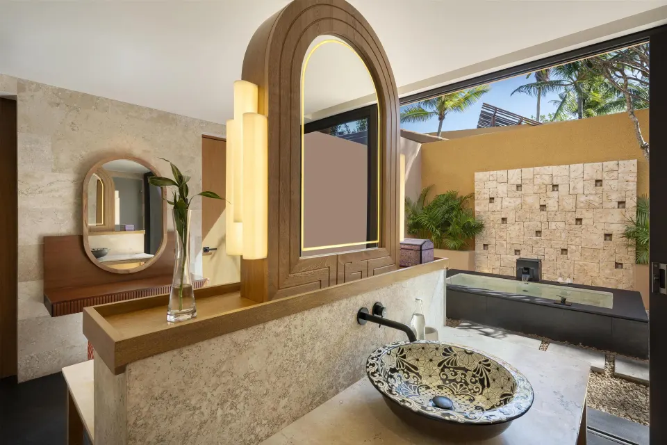 Bathroom vanity and outdoor tub in the Serenity Two Bedroom Pool Villa at Banyan Tree Mayakoba.