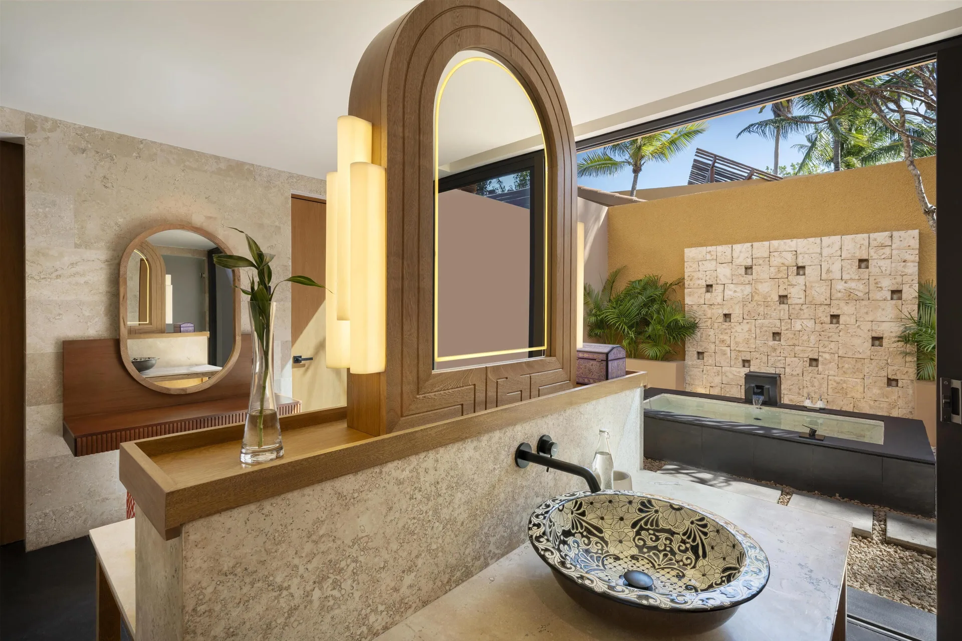 Bathroom vanity and outdoor tub in the Serenity Two Bedroom Pool Villa at Banyan Tree Mayakoba.