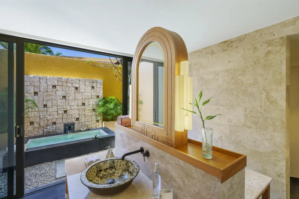 Wellbeing Sanctuary Pool Villa bathroom with vanity and outdoor tub at Banyan Tree Mayakoba.