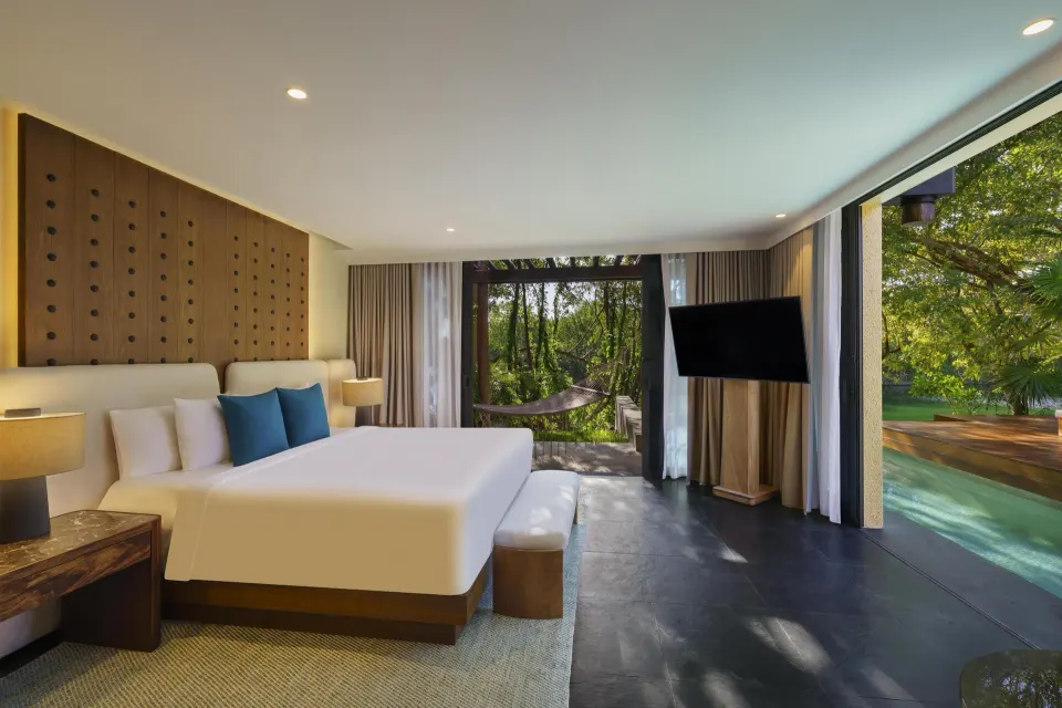 Wellbeing Sanctuary Pool Villa bedroom with king bed and pool view at Banyan Tree Mayakoba.