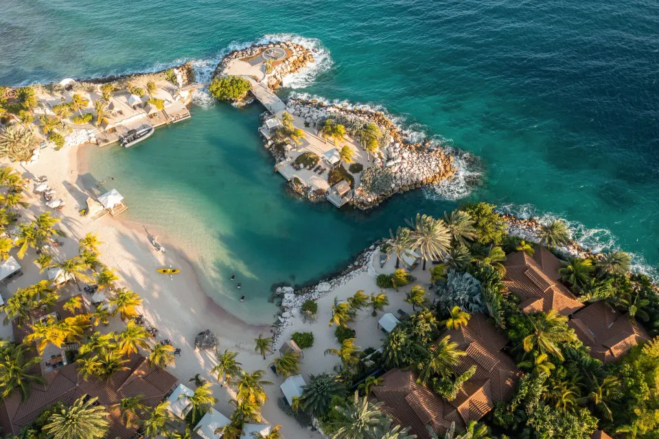 Aerial view of the resort coastline, beach and villas at Baoase Luxury Resort