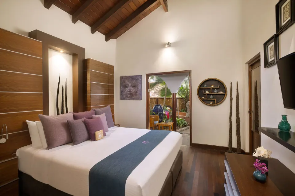 King bed room interior with tropical patio visible at Baoase Luxury Resort