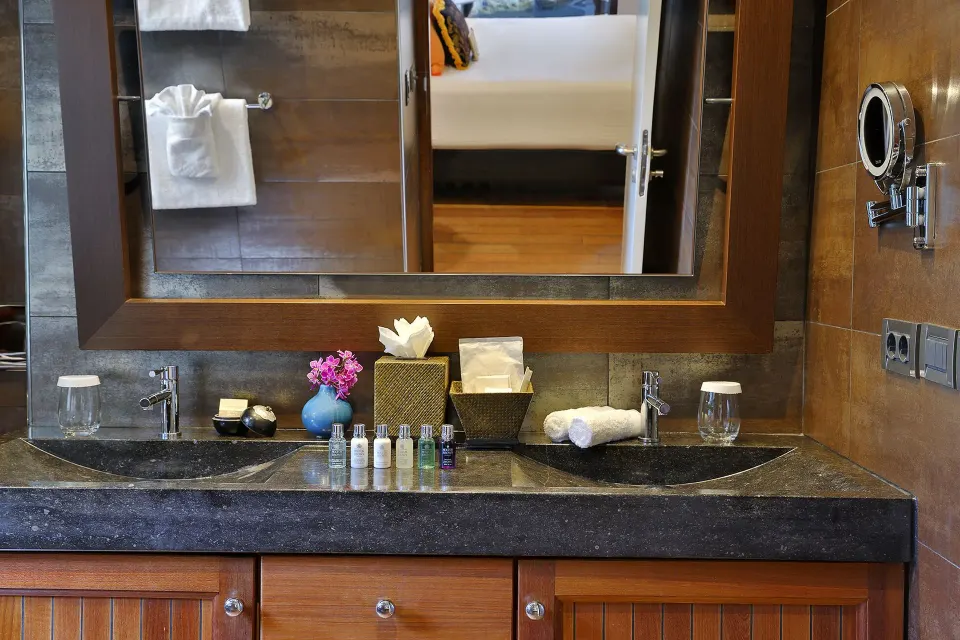 Bathroom vanity with toiletries and mirror at Baoase Luxury Resort