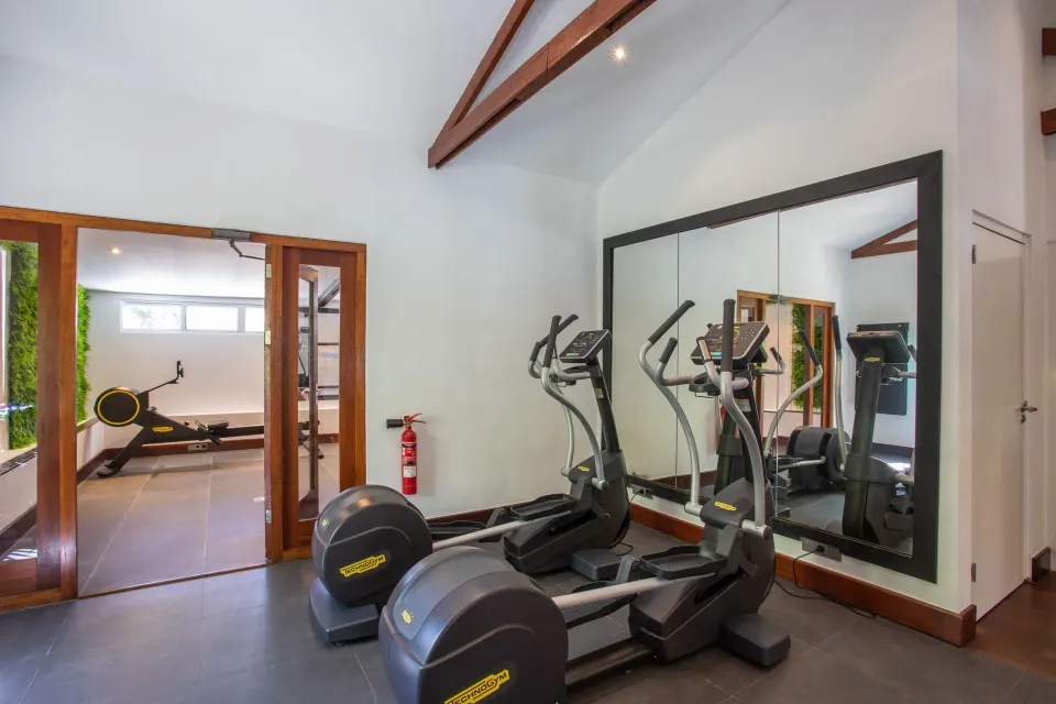 Small fitness room with cardio machines at Baoase Luxury Resort