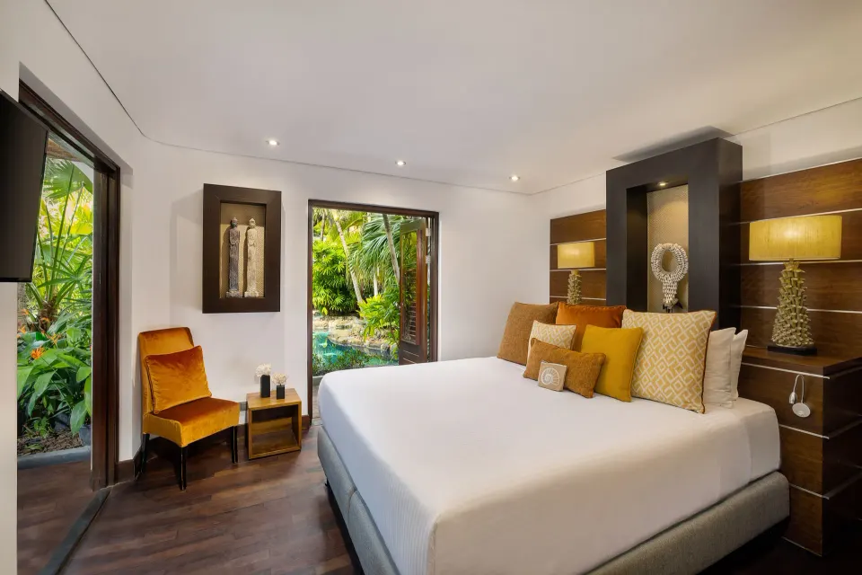 King bed room with garden view through open doors at Baoase Luxury Resort