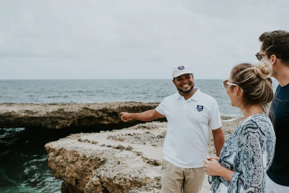 Resort guide pointing out coastal views to guests at Baoase Luxury Resort