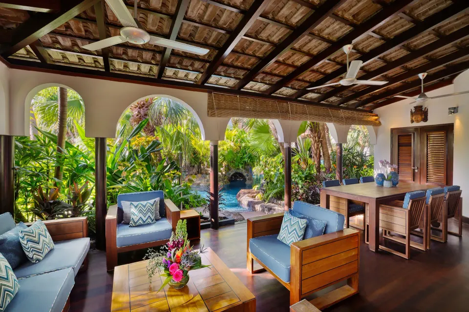 Open-plan lounge and bar area overlooking a garden pool at Baoase Luxury Resort