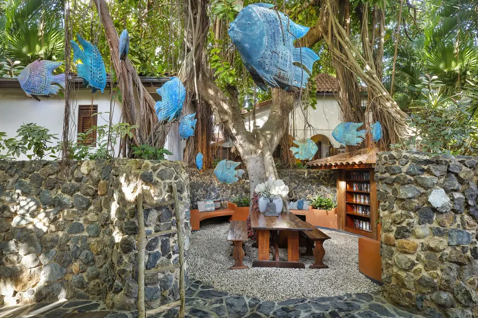 Secluded Banyan Tree Room courtyard with hanging fish sculptures at Baoase Luxury Resort