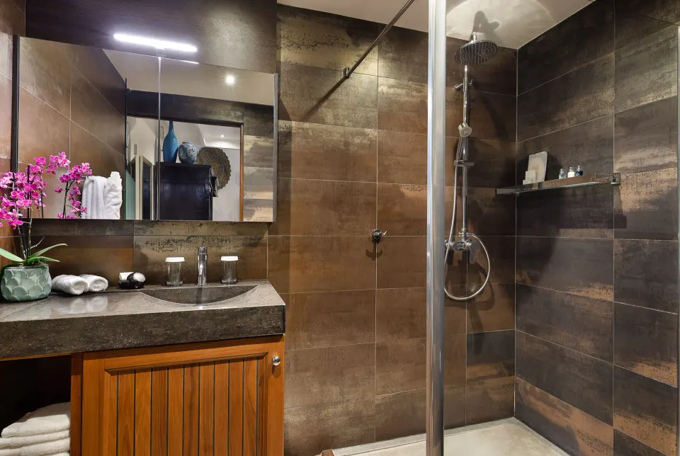 Loft Room bathroom shower with dark tile and vanity at Baoase Luxury Resort