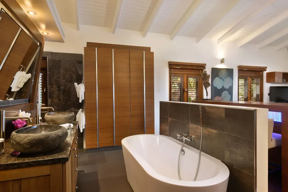 Private Jacuzzi Honeymoon Suite bathroom with freestanding tub and dual sinks at Baoase Luxury Resort