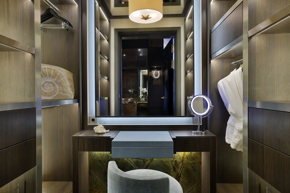 Dressing area with vanity and illuminated mirror in a Private Pool Beachfront Suite at Baoase Luxury Resort