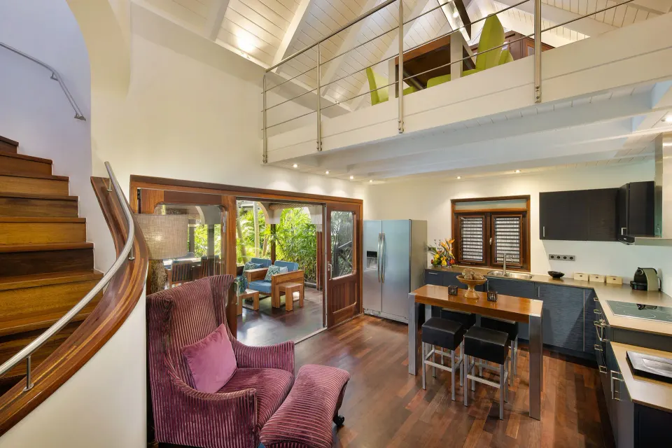 Villa interior showing living area, kitchenette and mezzanine in a private pool villa at Baoase Luxury Resort