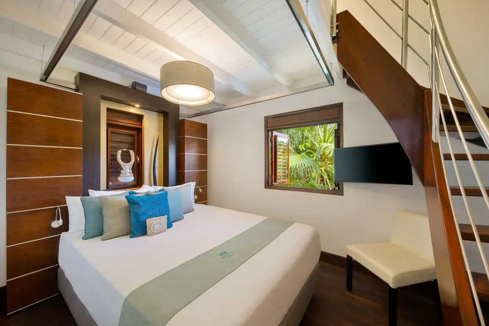 Two-level Tropical Pool Villa bedroom with loft and king bed at Baoase Luxury Resort